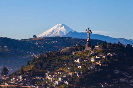 View of El Panecillo in the center of Quito with the Cotopaxi in the backgroundの写真素材