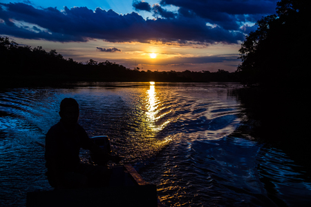 Reflection of the sun at sunset in the Limoncocha lagoon in the Ecuadorian Amazonの写真素材