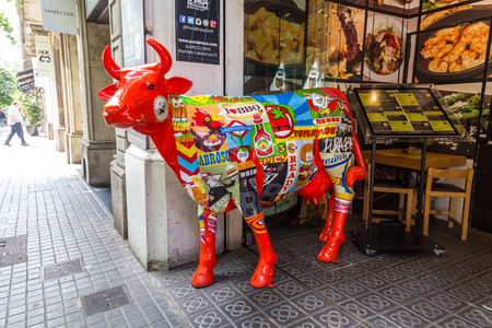 BARCELON, SPAIN, JUN 8, 2017: A cow painted red and commercials, catches the attention of customers of the restaurant Purabrasa.のeditorial素材