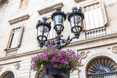 Iron and glass lanterns adorned with brightly colored flowersのeditorial素材