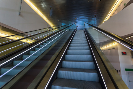 Mechanical escalators with white linear lights inside a buildingのeditorial素材