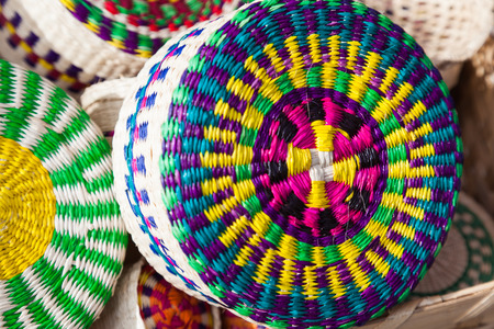 Vegetable fiber baskets, toquilla straw, painted with various colors in the artisan market.