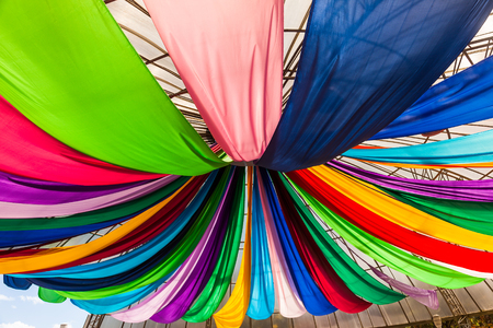 Fabrics of various colors hanging from a ceilingの写真素材