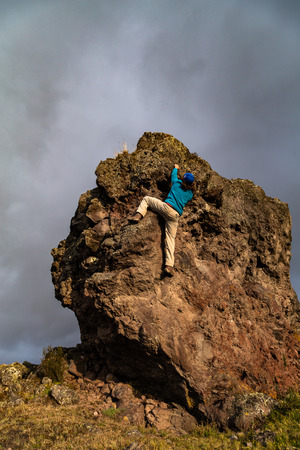 Man climbing a rock wall in freestyleの写真素材