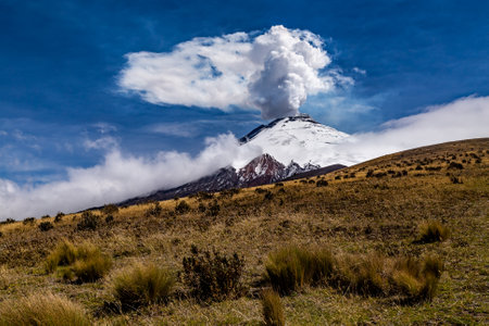 Cotopaxi in eruption, an immense column of steam rises a few thousand meters above the volcano.の写真素材