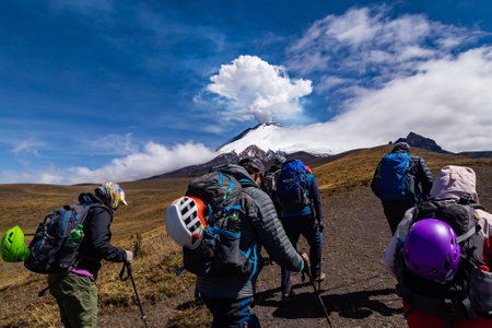 Cotopaxi in eruption, an immense column of steam rises a few thousand meters above the volcano.