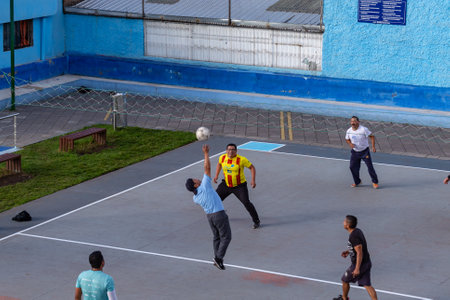 Quito, Ecuador, June 3, 2023: Residents of the Las Casas neighborhood spend their free time playing ecuavoley, a form of volleyball that is played informally between three people on each side in the city parks.のeditorial素材