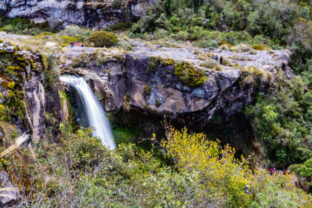 Waterfall formed of crystalline water that is born in the cotopaxi and runs through a channel in volcanic rockの写真素材