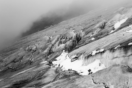 Mountain landscape with snow and fog. Cayambe volcano. Black and white.