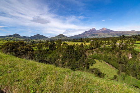 Ilinizas Volcano, Andean landscape with its crop fields and mountains showing their greenery on a clear morning, eastern view.の写真素材