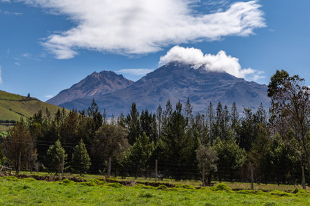 Ilinizas Volcano, Andean landscape with its crop fields and mountains showing their greenery on a clear morning, south eastern view.の写真素材