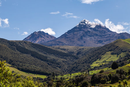 Ilinizas Volcano, Andean landscape with its crop fields and mountains showing their greenery on a clear morning, south eastern view.の写真素材