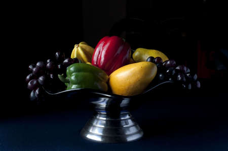 Bowl of fruit and vegetables with dark backgroundの写真素材