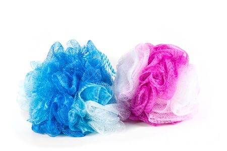 Blue and pink loofahs isolated on white backgroundの写真素材