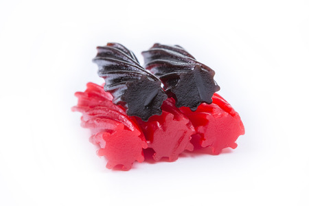 Strawberry and Black Licorice pieces isolated on white backgroundの写真素材