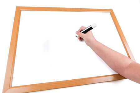 Child writing on a dry erase board with a markerの写真素材