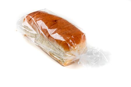 Loaf of whole grain bread in a bag isolated on white backgroundの写真素材