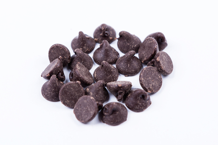 Chocolate baking chips isolated on white backgroundの写真素材