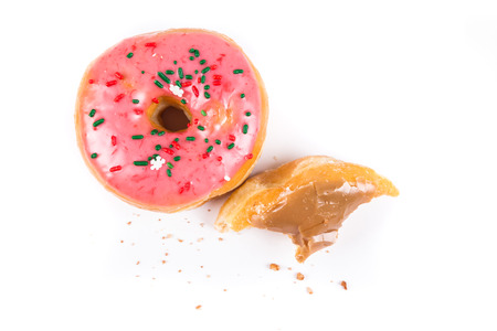 Partially eaten donuts with a bite taken out isolated on a white backgroundの写真素材