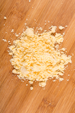 Cheese powder mix isolated on wood backgroundの写真素材