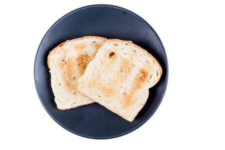 Two whole grain slices of bread toasted on a ceramic plate isolated on white backgroundの写真素材