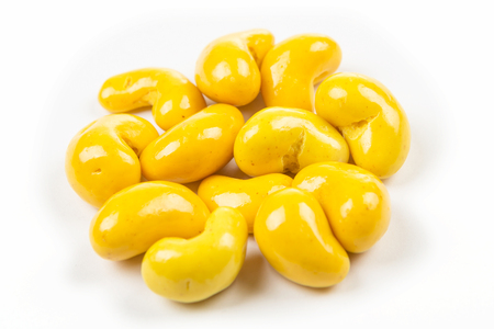 Candied curry cashews isolated on white backgroundの写真素材