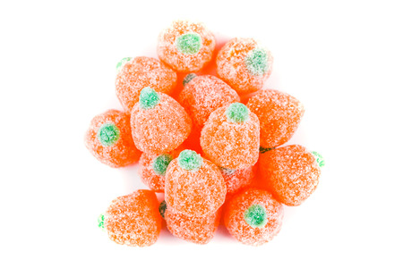 Pile of sour pumpkin chewy candies isolated on white backgroundの写真素材