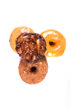 Assorted glazed and frosted donuts isolated on a white backgroundの写真素材