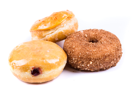 Assorted glazed and frosted donuts isolated on a white backgroundの写真素材