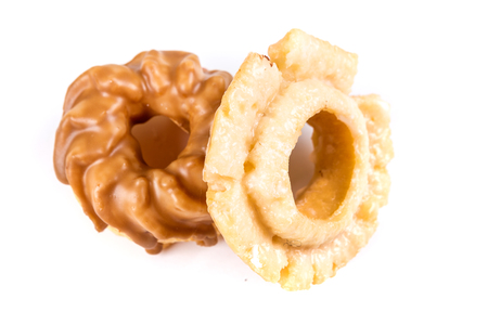 Assorted glazed and frosted donuts isolated on a white backgroundの写真素材