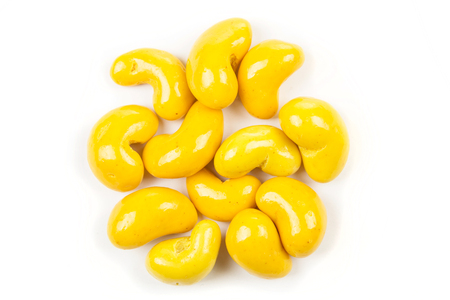 Candied curry cashews isolated on white backgroundの写真素材