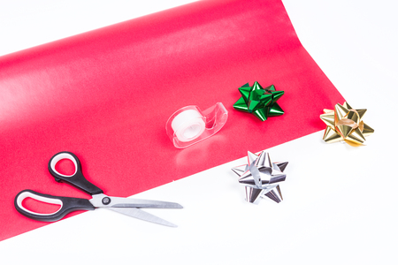 Wrapping paper, scissors, tape and bows isolated on white backgroundの写真素材