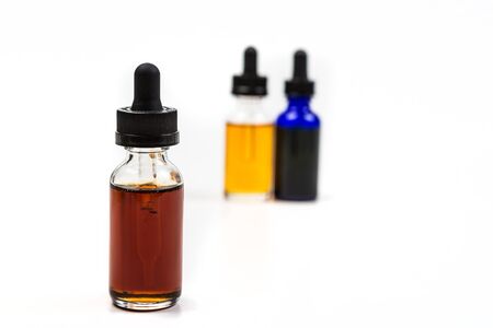 Flavored vape juice with shallow depth of field and objects out of focus isolated on white backgroundの写真素材