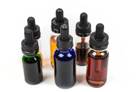 Assorted flavors of vape juice isolated on white backgroundの写真素材