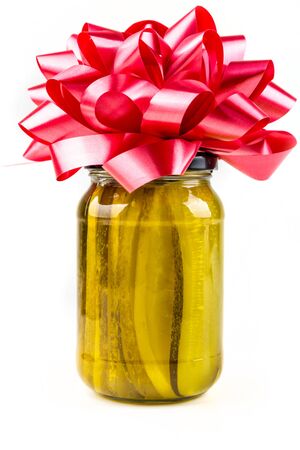 Jar of pickles with bow isolated on white backgroundの写真素材