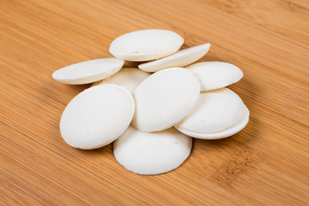 Vanilla candy melts isolated on wood backgroundの写真素材