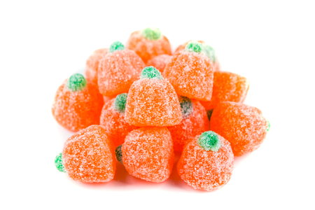 Pile of sour pumpkin chewy candies isolated on white backgroundの写真素材