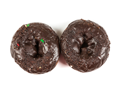 Chocolate frosted cake donuts isolated on a white backgroundの写真素材
