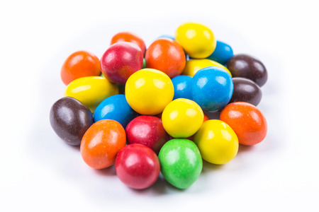 Chocolate covered peanuts with a candy shell isolated on white backgroundの写真素材
