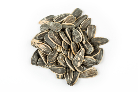 Salted roasted sunflower seeds isolated on white backgroundの写真素材