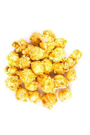 Pile of caramel popcorn isolated on white backgroundの写真素材