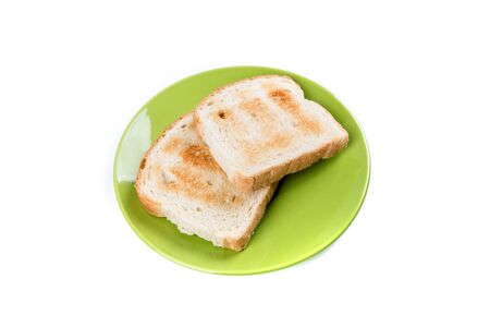 Two whole grain slices of bread toasted on a ceramic plate isolated on white backgroundの写真素材