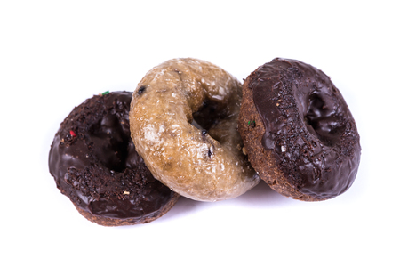 Assorted glazed and frosted donuts isolated on a white backgroundの写真素材