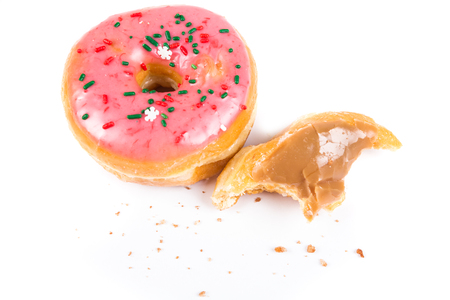 Partially eaten donuts with a bite taken out isolated on a white backgroundの写真素材