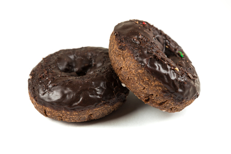 Chocolate frosted cake donuts isolated on a white backgroundの写真素材