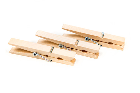 Three wood clothespins isolated on white backgroundの写真素材