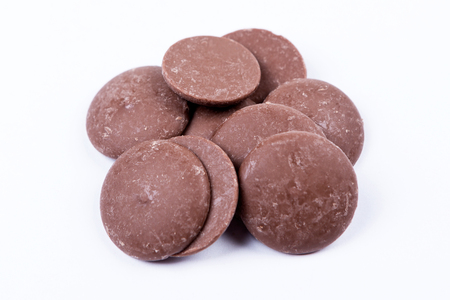 Milk chocolate melts isolated on white backgroundの写真素材