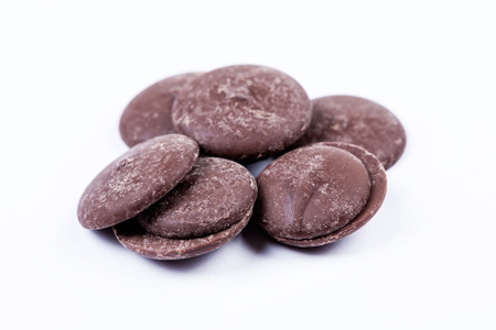 Bittersweet chocolate melts isolated on white backgroundの写真素材