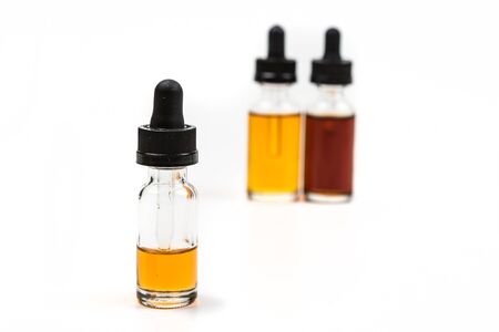 Flavored vape juice with shallow depth of field and objects out of focus isolated on white backgroundの写真素材
