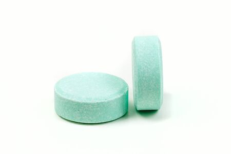 Minty antacid tablets isolated on white backgroundの写真素材